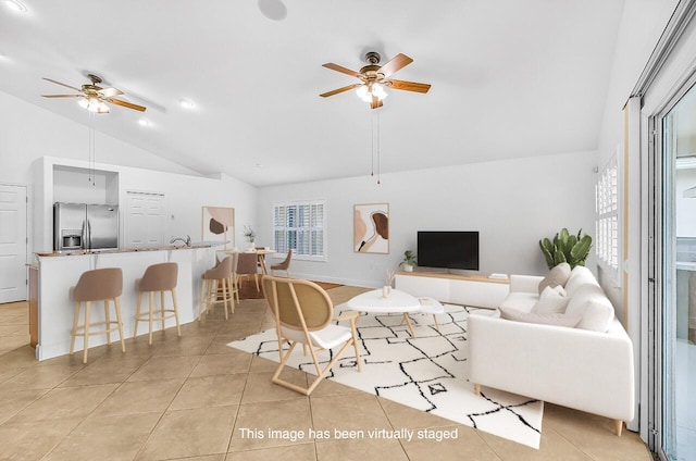 3024 Constellation Dr, Melbourne, FL 32940 - living area featuring ceiling fan, light tile patterned floors, and high vaulted ceiling
