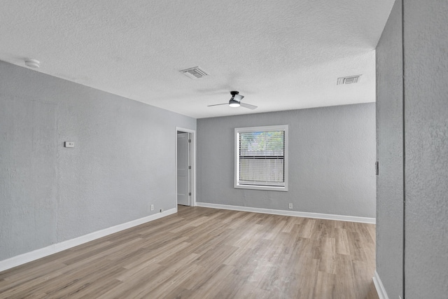 220 Walton Blvd, West Palm Beach, FL 33405 - spare room featuring wood finished floors, a ceiling fan, a textured wall, a textured ceiling, and baseboards
