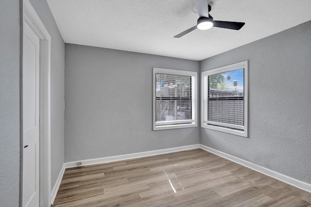 220 Walton Blvd, West Palm Beach, FL 33405 - unfurnished room featuring a textured wall, wood finished floors, ceiling fan, baseboards, and a textured ceiling