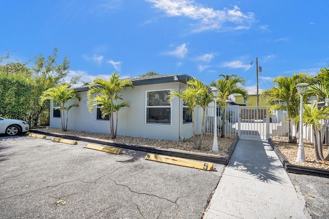 220 Walton Blvd, West Palm Beach, FL 33405 - view of front facade with uncovered parking and stucco siding