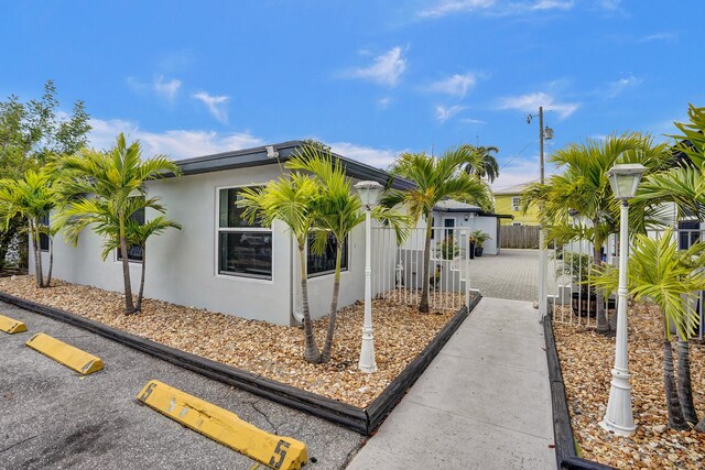 220 Walton Blvd, West Palm Beach, FL 33405 - view of home's exterior featuring stucco siding and driveway