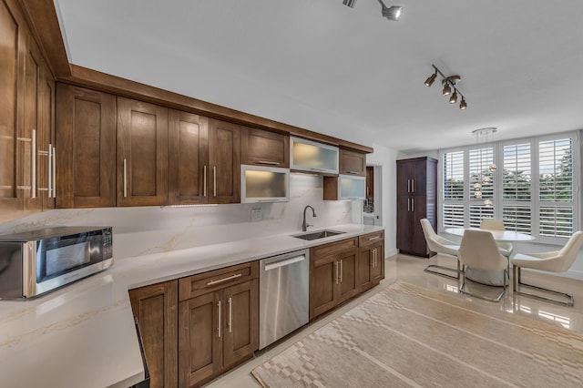 7572 Regency Lake Dr Unit 402, Boca Raton, FL 33433 - kitchen featuring stainless steel appliances, a sink, light countertops, glass insert cabinets, and hanging light fixtures