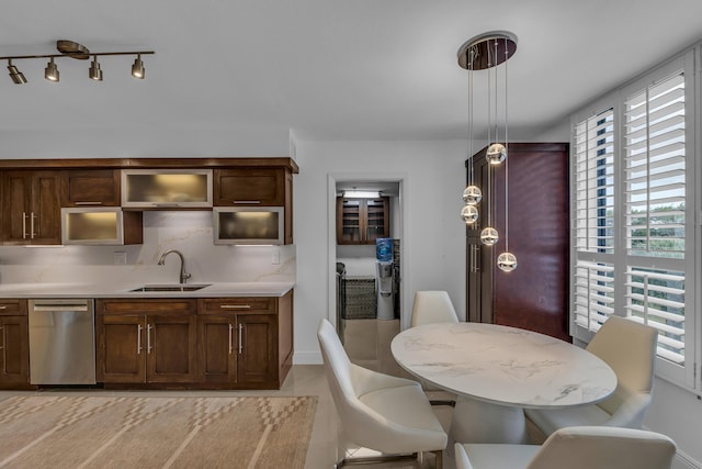 7572 Regency Lake Dr Unit 402, Boca Raton, FL 33433 - kitchen with stainless steel dishwasher, a sink, light countertops, hanging light fixtures, and dark brown cabinets