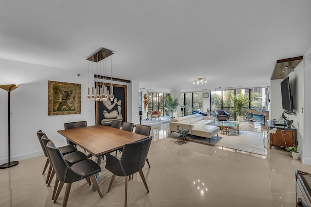 7572 Regency Lake Dr Unit 402, Boca Raton, FL 33433 - dining area with a chandelier, baseboards, floor to ceiling windows, and light tile patterned floors