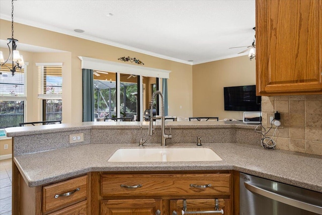 1456 SW Del Rio Blvd, Port Saint Lucie, FL 34953 - kitchen featuring stainless steel dishwasher, a sink, brown cabinets, ornamental molding, and decorative light fixtures