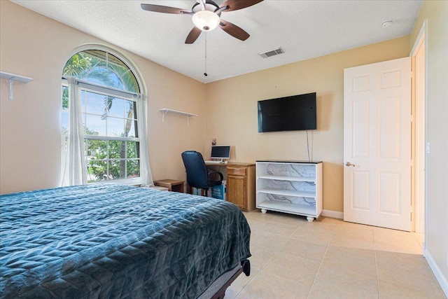 1456 SW Del Rio Blvd, Port Saint Lucie, FL 34953 - bedroom featuring light tile patterned floors, a textured ceiling, baseboards, and a ceiling fan
