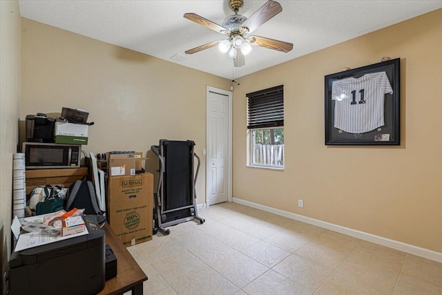 1456 SW Del Rio Blvd, Port Saint Lucie, FL 34953 - office featuring a ceiling fan, baseboards, light tile patterned floors, and a textured ceiling