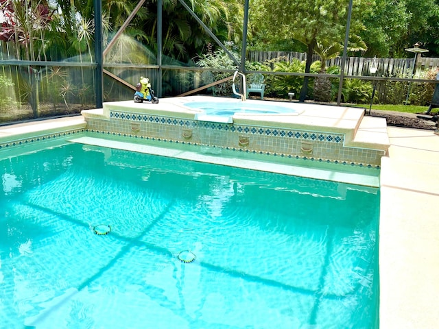 1456 SW Del Rio Blvd, Port Saint Lucie, FL 34953 - view of swimming pool featuring an in-ground hot tub and glass enclosure