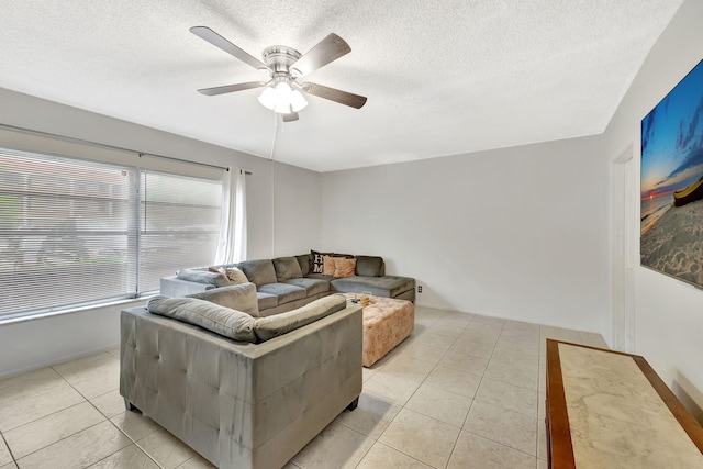 600 Pine Dr Unit 104, Pompano Beach, FL 33060 - living room with light tile patterned floors, a ceiling fan, a textured ceiling, and baseboards
