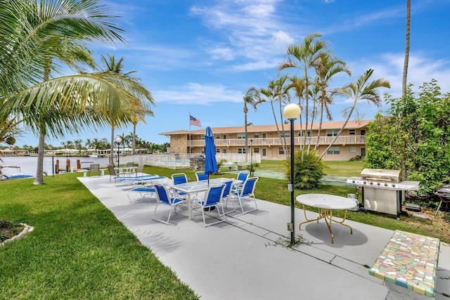 600 Pine Dr Unit 104, Pompano Beach, FL 33060 - view of patio with a grill and a water view