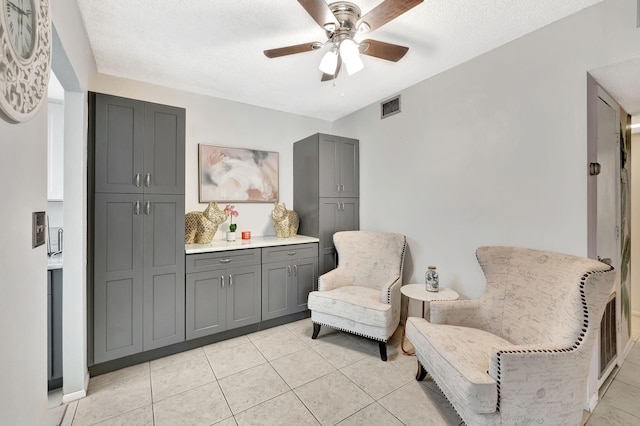 600 Pine Dr Unit 104, Pompano Beach, FL 33060 - living area featuring a ceiling fan, a textured ceiling, and light tile patterned floors