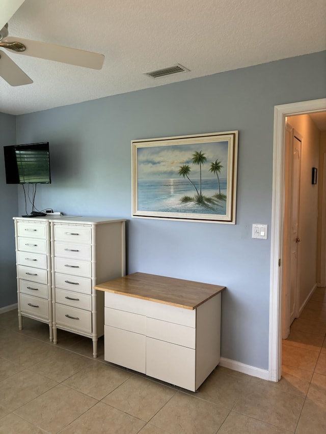 9935 Papaya Tree Trl Unit B, Boynton Beach, FL 33436 - unfurnished bedroom with light tile patterned floors, baseboards, ceiling fan, and a textured ceiling