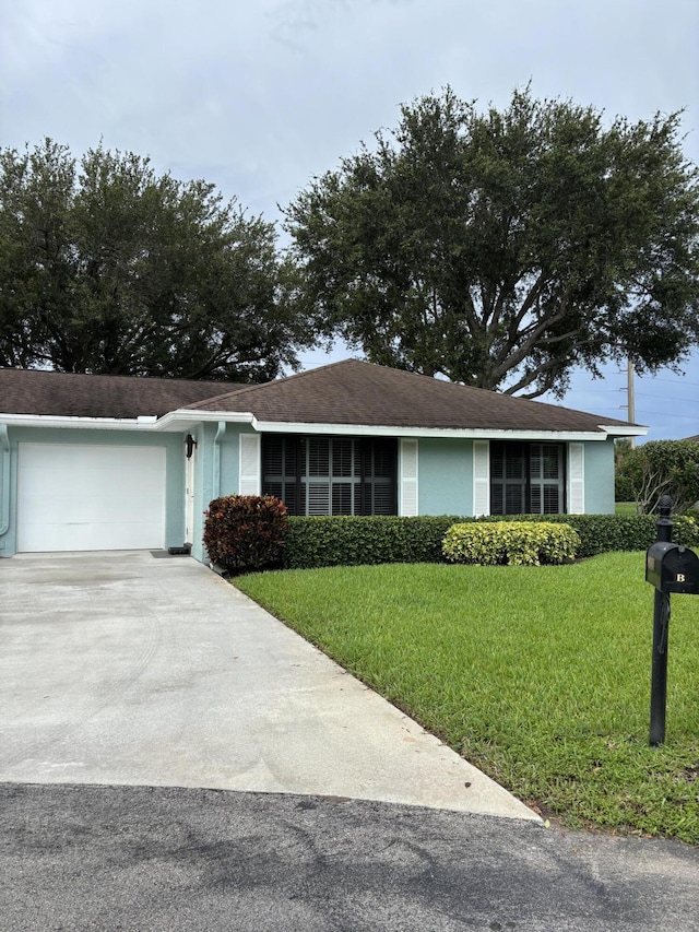 9935 Papaya Tree Trl Unit B, Boynton Beach, FL 33436 - ranch-style house with concrete driveway, an attached garage, a front lawn, and stucco siding