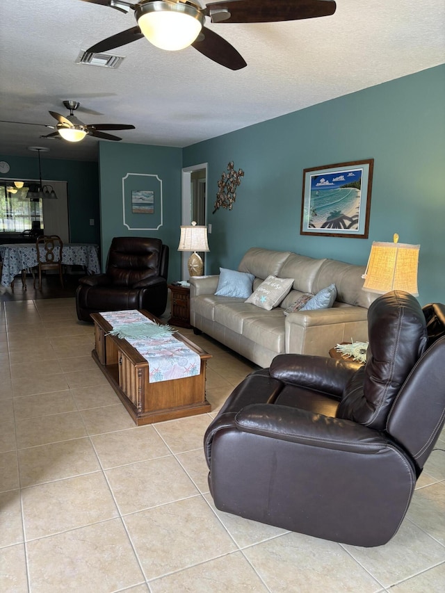 9935 Papaya Tree Trl Unit B, Boynton Beach, FL 33436 - living room featuring ceiling fan, light tile patterned floors, and a textured ceiling