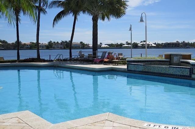 160 Yacht Club Way Unit 309, Hypoluxo, FL 33462 - swimming pool featuring a water view