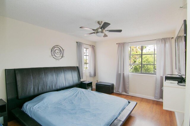 160 Yacht Club Way Unit 309, Hypoluxo, FL 33462 - bedroom with wood finished floors, baseboards, and ceiling fan