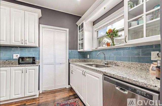 616 Claremore Dr Unit 1, 2, 3, West Palm Beach, FL 33401 - kitchen featuring dishwasher, a sink, white cabinets, glass insert cabinets, and backsplash