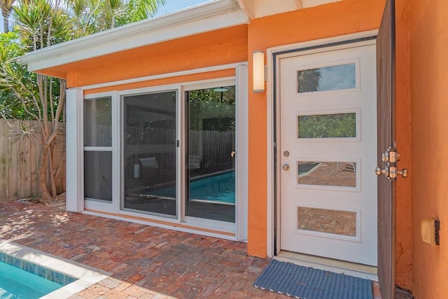 616 Claremore Dr Unit 1, 2, 3, West Palm Beach, FL 33401 - property entrance featuring a patio and stucco siding