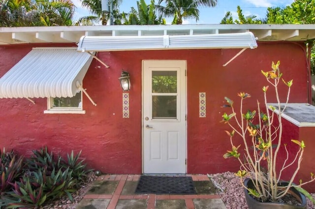 616 Claremore Dr Unit 1, 2, 3, West Palm Beach, FL 33401 - doorway to property featuring stucco siding