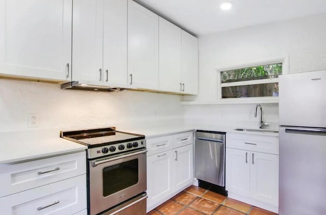 616 Claremore Dr Unit 1, 2, 3, West Palm Beach, FL 33401 - kitchen featuring stainless steel appliances, a sink, light countertops, and white cabinets
