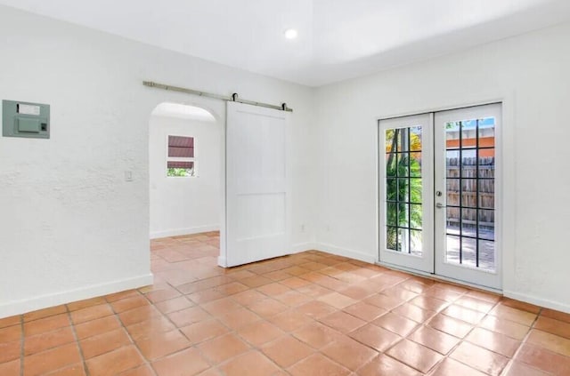 616 Claremore Dr Unit 1, 2, 3, West Palm Beach, FL 33401 - spare room featuring healthy amount of natural light, a barn door, french doors, baseboards, and recessed lighting