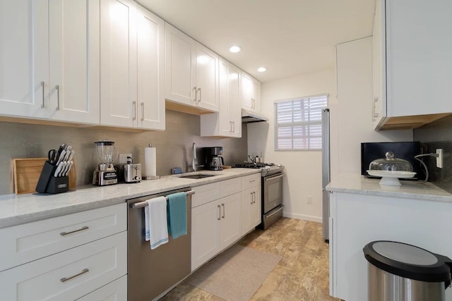 616 Claremore Dr Unit 1, 2, 3, West Palm Beach, FL 33401 - kitchen with stainless steel appliances, a sink, under cabinet range hood, white cabinets, and tasteful backsplash