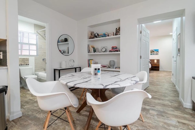 616 Claremore Dr Unit 1, 2, 3, West Palm Beach, FL 33401 - dining area featuring built in features, light wood-style floors, and baseboards
