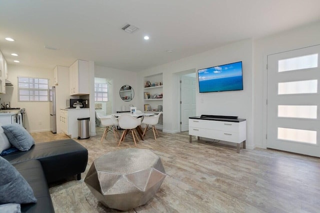 616 Claremore Dr Unit 1, 2, 3, West Palm Beach, FL 33401 - living room featuring built in shelves, light wood finished floors, recessed lighting, and baseboards