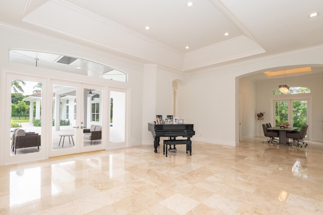 8246 Man O War Rd, Palm Beach Gardens, FL 33418 - sitting room with arched walkways, french doors, crown molding, a tray ceiling, and light marble finish flooring