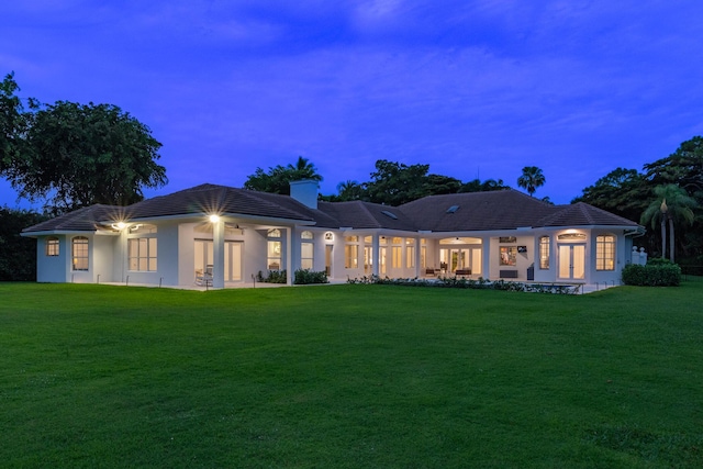 8246 Man O War Rd, Palm Beach Gardens, FL 33418 - back of property with a chimney, a yard, and stucco siding