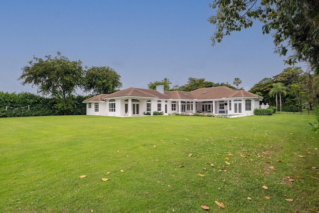 8246 Man O War Rd, Palm Beach Gardens, FL 33418 - back of property featuring a lawn and a chimney
