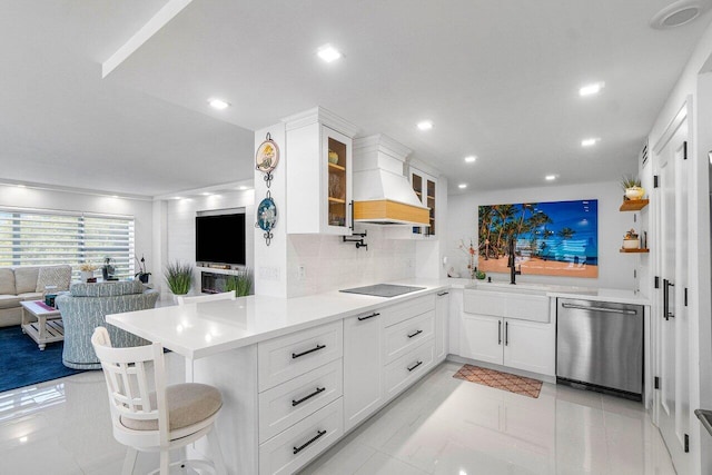 875 E Camino Real Unit 3E, Boca Raton, FL 33432 - kitchen featuring stainless steel dishwasher, premium range hood, a peninsula, glass insert cabinets, and light countertops