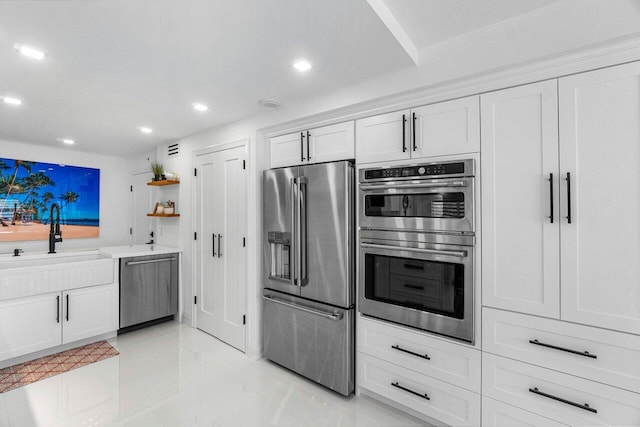 875 E Camino Real Unit 3E, Boca Raton, FL 33432 - kitchen featuring appliances with stainless steel finishes, open shelves, a sink, recessed lighting, and white cabinetry