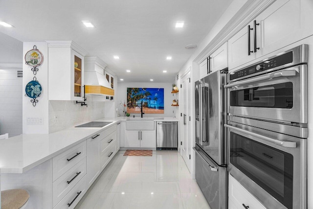 875 E Camino Real Unit 3E, Boca Raton, FL 33432 - kitchen featuring stainless steel appliances, a sink, white cabinetry, recessed lighting, and light countertops