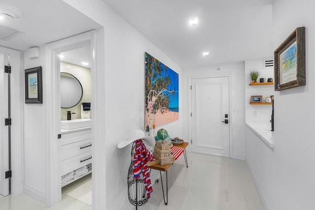875 E Camino Real Unit 3E, Boca Raton, FL 33432 - corridor with a sink, baseboards, and recessed lighting