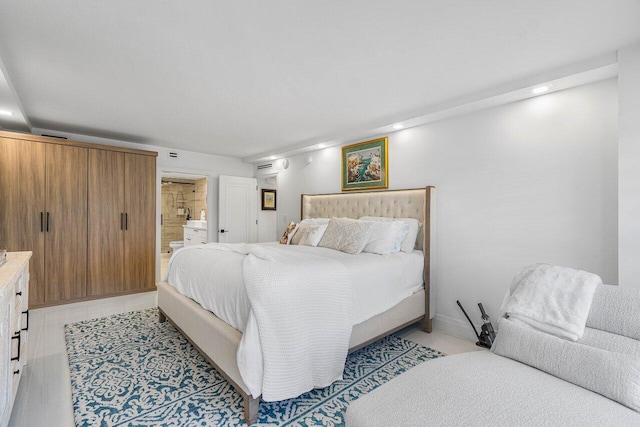 875 E Camino Real Unit 3E, Boca Raton, FL 33432 - bedroom with connected bathroom and recessed lighting