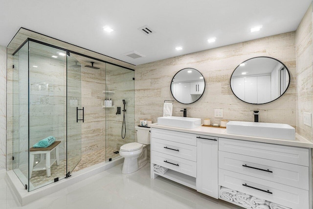 875 E Camino Real Unit 3E, Boca Raton, FL 33432 - bathroom featuring a shower stall, double vanity, tile walls, toilet, and recessed lighting