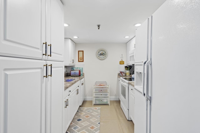 899 Jeffery St Unit 301, Boca Raton, FL 33487 - kitchen with white appliances, white cabinetry, recessed lighting, a sink, and light tile patterned flooring