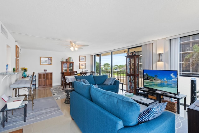 899 Jeffery St Unit 301, Boca Raton, FL 33487 - living area featuring a ceiling fan, floor to ceiling windows, and a textured ceiling
