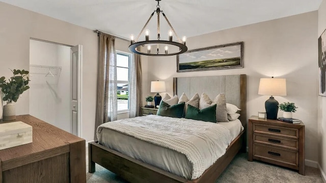 1681 Whistlegrass Ln, Loxahatchee, FL 33470 - carpeted bedroom featuring a chandelier, a walk in closet, and a closet