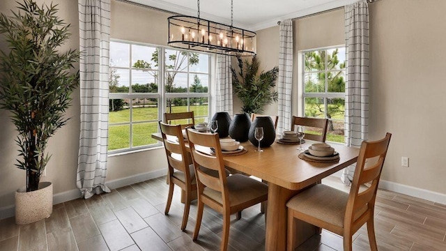 1681 Whistlegrass Ln, Loxahatchee, FL 33470 - dining room featuring baseboards, wood finish floors, a chandelier, and crown molding