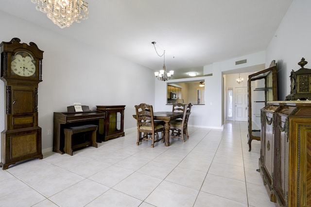 370 Golfview Rd Unit 103, North Palm Beach, FL 33408 - dining area with a chandelier and light tile patterned flooring