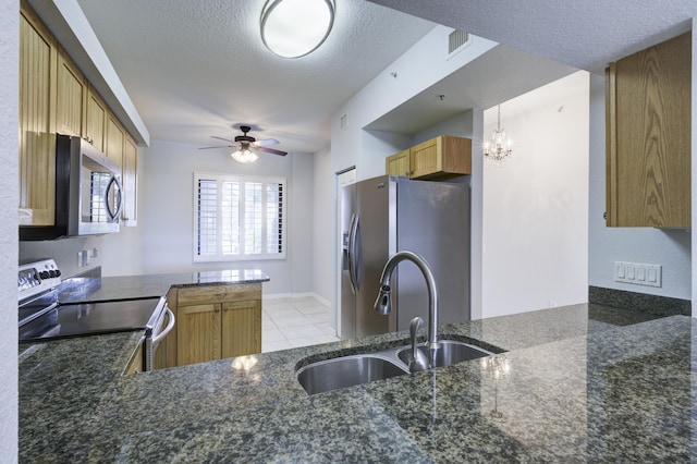 370 Golfview Rd Unit 103, North Palm Beach, FL 33408 - kitchen featuring appliances with stainless steel finishes, a textured ceiling, dark stone counters, light tile patterned flooring, and ceiling fan
