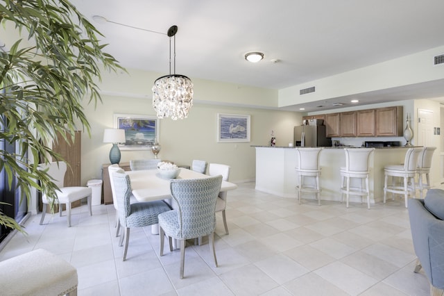 370 Golfview Rd Unit 103, North Palm Beach, FL 33408 - dining space with light tile patterned flooring and a chandelier