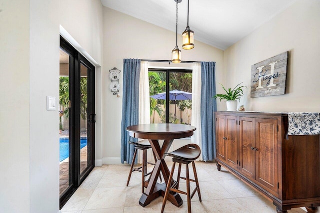 2626 NW 42nd St, Boca Raton, FL 33434 - dining room with lofted ceiling, light tile patterned flooring, and baseboards
