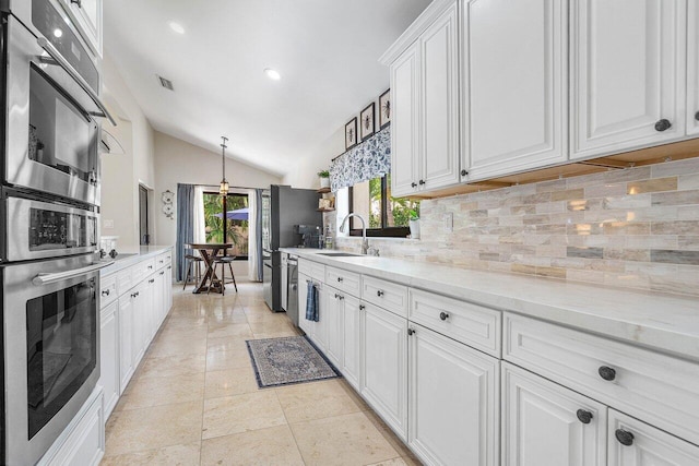 2626 NW 42nd St, Boca Raton, FL 33434 - kitchen featuring a sink, decorative backsplash, vaulted ceiling, white cabinets, and recessed lighting