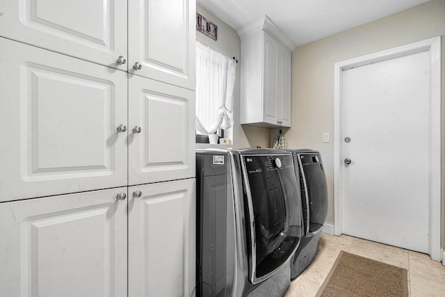 2626 NW 42nd St, Boca Raton, FL 33434 - washroom featuring washer and clothes dryer, cabinet space, and light tile patterned flooring
