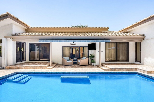 2626 NW 42nd St, Boca Raton, FL 33434 - rear view of house featuring a tile roof, an outdoor pool, and a patio area