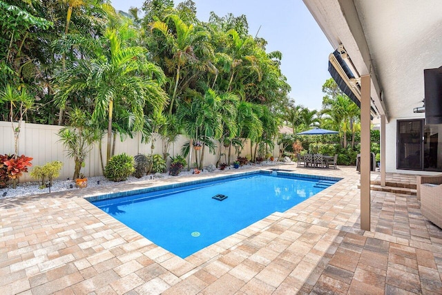 2626 NW 42nd St, Boca Raton, FL 33434 - view of pool featuring a patio area, a fenced backyard, and outdoor dining space
