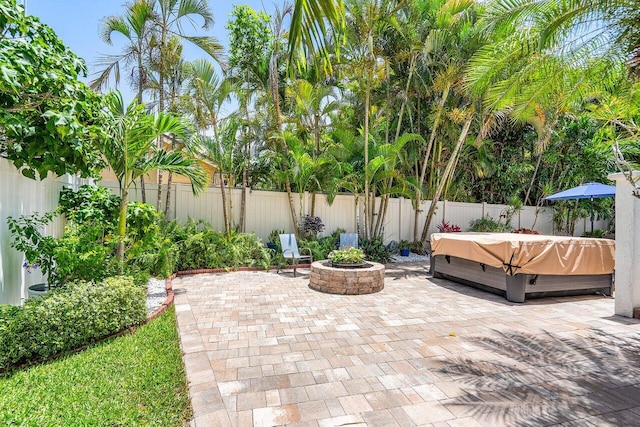 2626 NW 42nd St, Boca Raton, FL 33434 - fenced backyard with a hot tub, a patio, and an outdoor fire pit